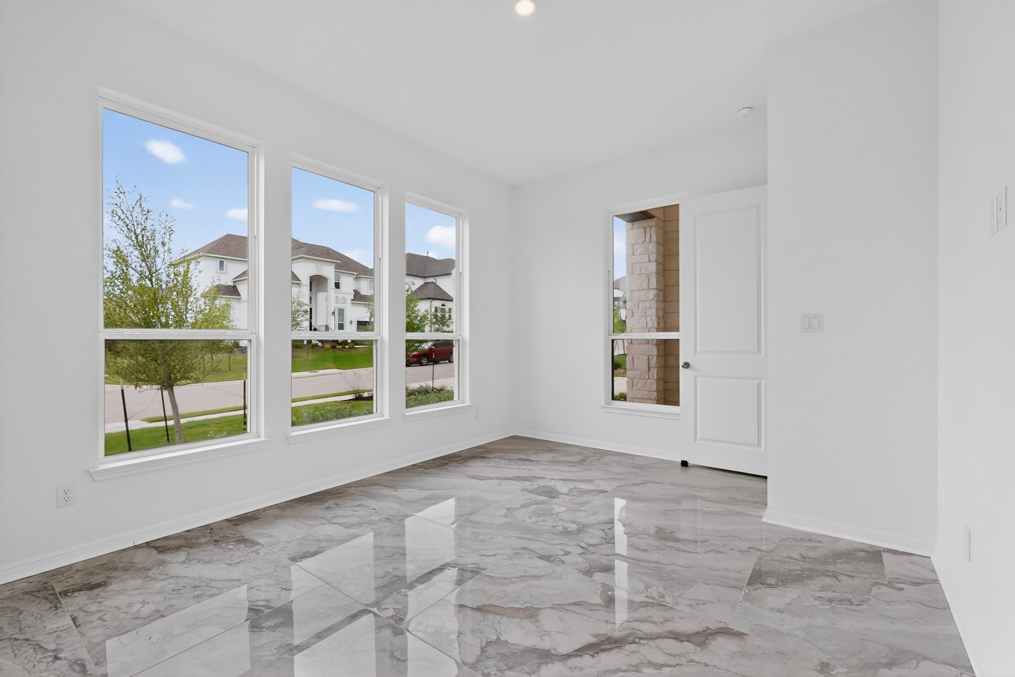 2308 Mondello Path Leander, TX 78641 - Photo 17 of 39 Natural light pours into this room, highlighting the elegant stone tile flooring.