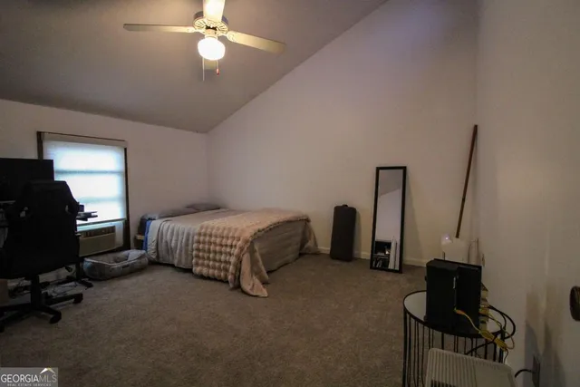 a view of a room with a hanging light and hardwood floor