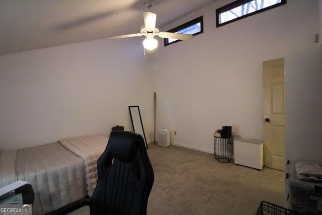 a bedroom with a bed and a ceiling fan