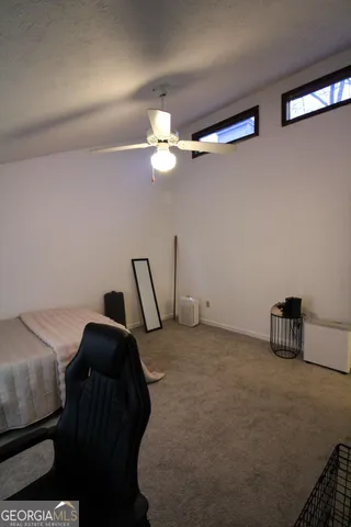 a bedroom with a bed and a chair