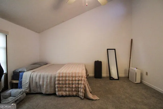 a view of a livingroom with workspace and a window