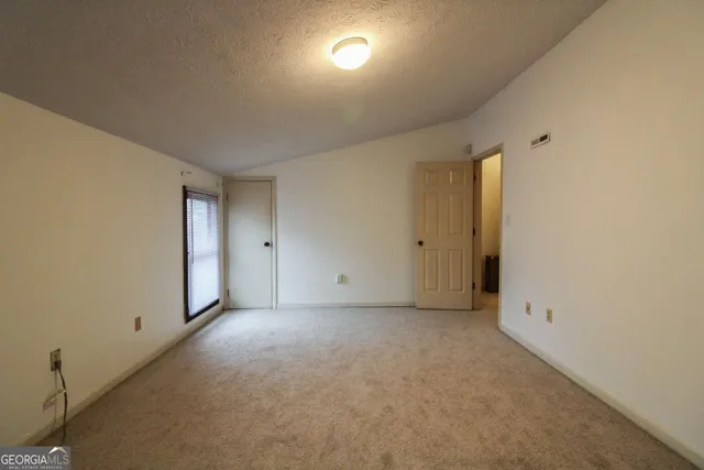 an empty room with windows and entrance