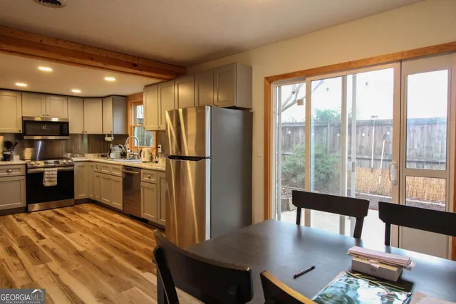 a kitchen with refrigerator a sink and cabinets