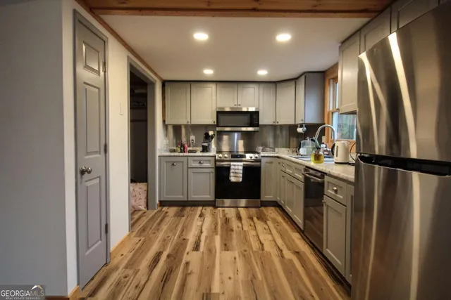 a kitchen with granite countertop stainless steel appliances and refrigerator