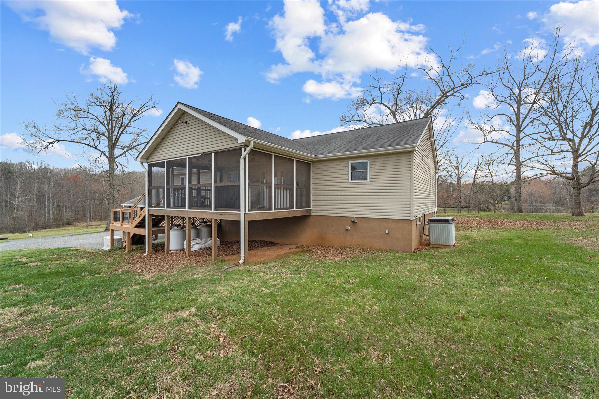 9107 Grasty Gold Mine Road Rhoadesville, VA 22542 - Photo 36 of 70 a view of a house with a yard and sitting area