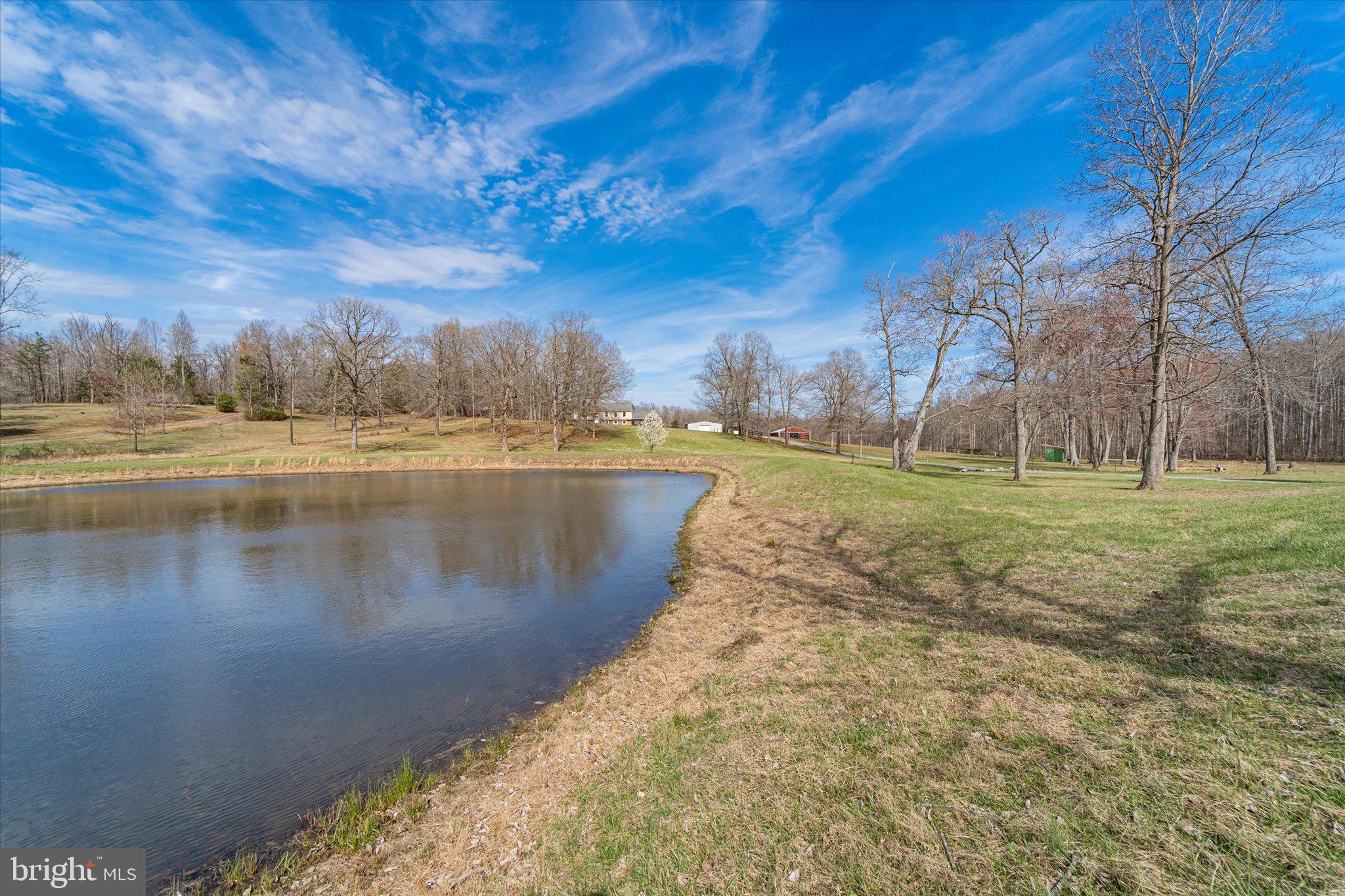 9107 Grasty Gold Mine Road Rhoadesville, VA 22542 - Photo 57 of 70 a view of a lake with a yard