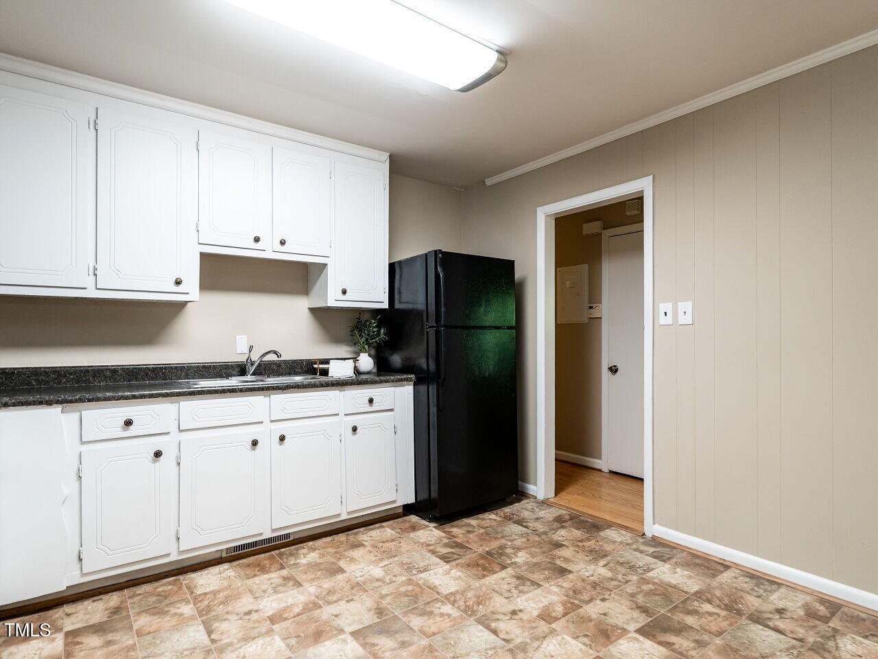 829 Greenwich Street Raleigh, NC 27610 - Photo 12 of 29 a kitchen with granite countertop a refrigerator and a sink