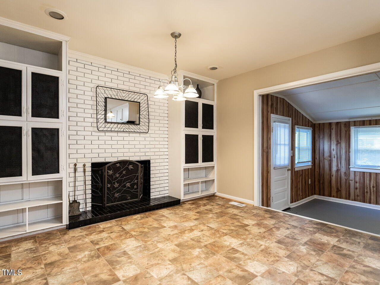 829 Greenwich Street Raleigh, NC 27610 - Photo 15 of 29 a view of an empty room with fire place and a window