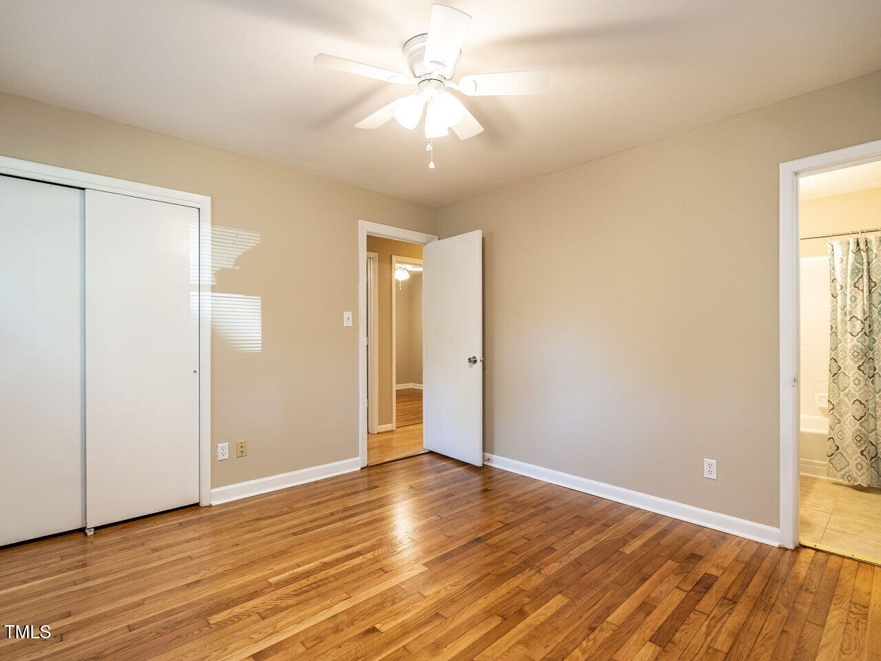829 Greenwich Street Raleigh, NC 27610 - Photo 21 of 29 an empty room with wooden floor and windows