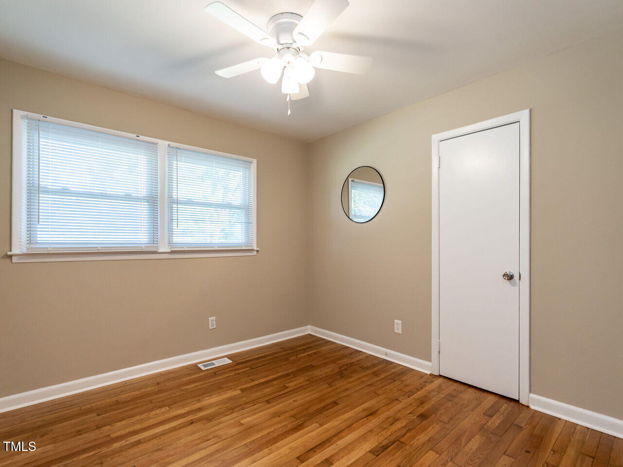 829 Greenwich Street Raleigh, NC 27610 - Photo 25 of 29 a view of empty room with wooden floor and fan