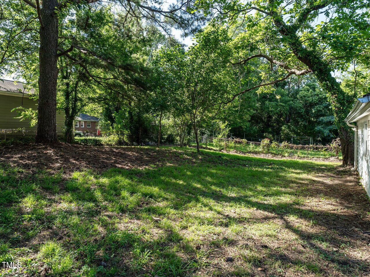 829 Greenwich Street Raleigh, NC 27610 - Photo 27 of 29 a view of outdoor space with green field and trees