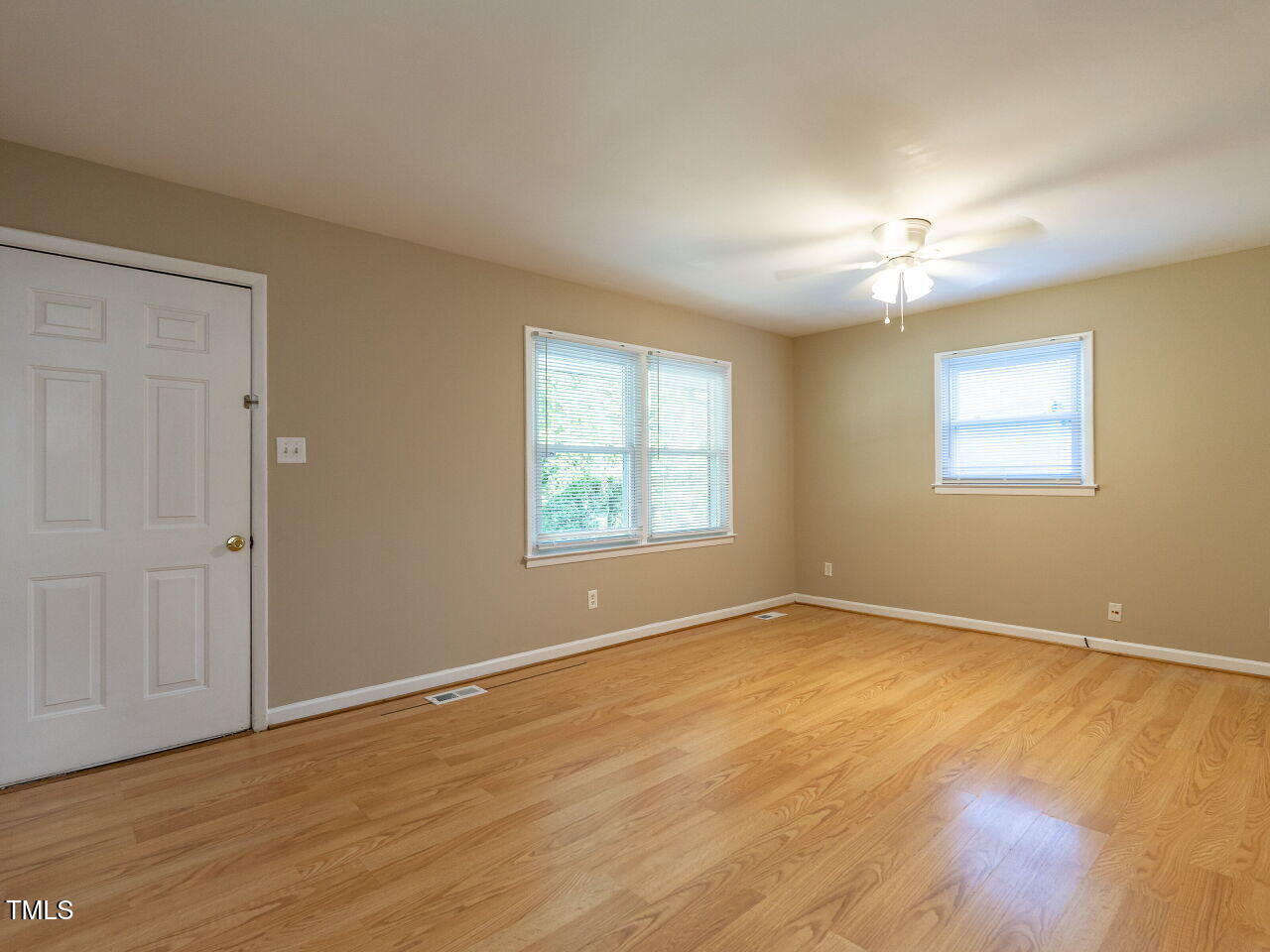 829 Greenwich Street Raleigh, NC 27610 - Photo 2 of 29 a view of empty room with wooden floor and fan