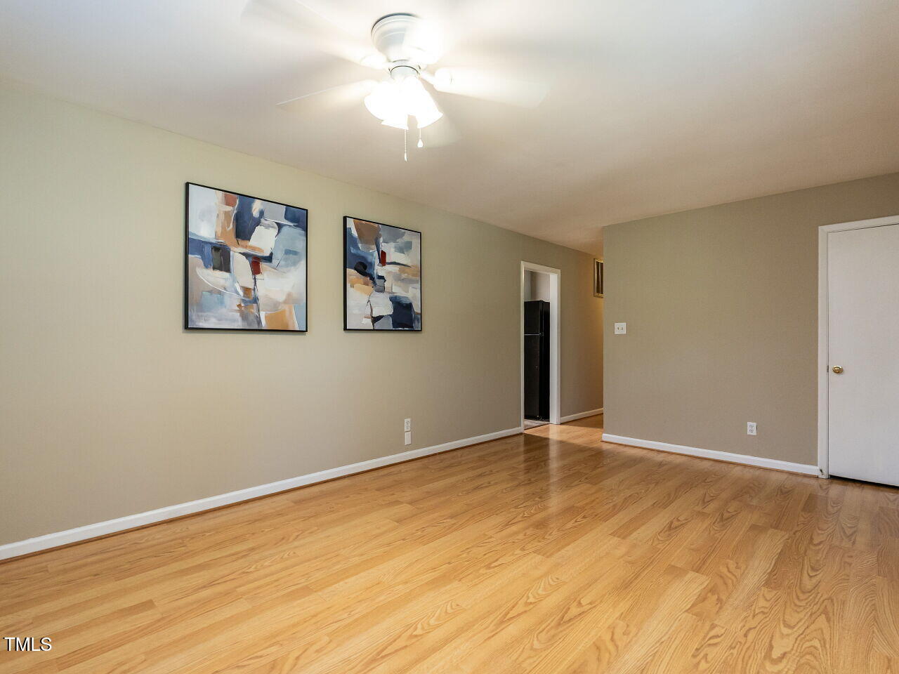 829 Greenwich Street Raleigh, NC 27610 - Photo 9 of 29 a view of an empty room with window and wooden floor