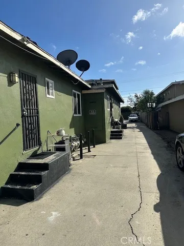 a view of a porch with furniture and floor to ceiling window