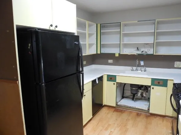 a kitchen with a refrigerator and a sink