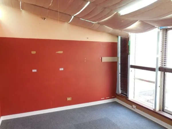 a view of a livingroom with an empty space and a window
