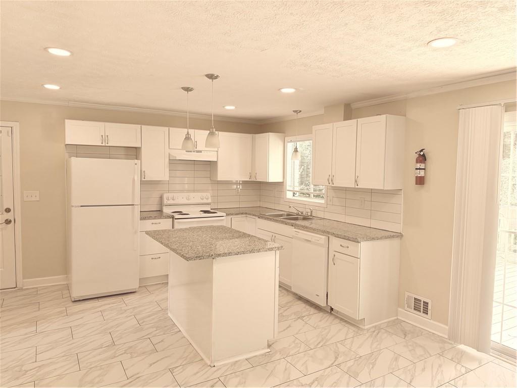 4707 Riverwood Circle Decatur, GA 30035 - Photo 7 of 17 a kitchen with a sink a refrigerator and cabinets