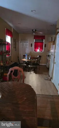 a view of a room with furniture and wooden floor