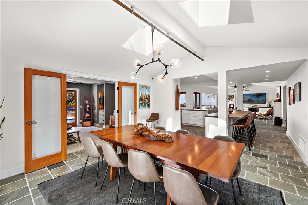 3085 Nestall Road Laguna Beach, CA 92651 - Photo 11 of 33 a dining room with furniture a kitchen view and a chandelier