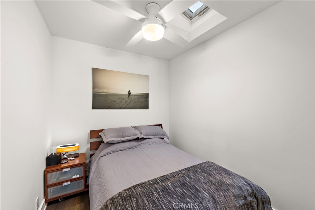 3085 Nestall Road Laguna Beach, CA 92651 - Photo 15 of 33 a bedroom with a bed and a chandelier