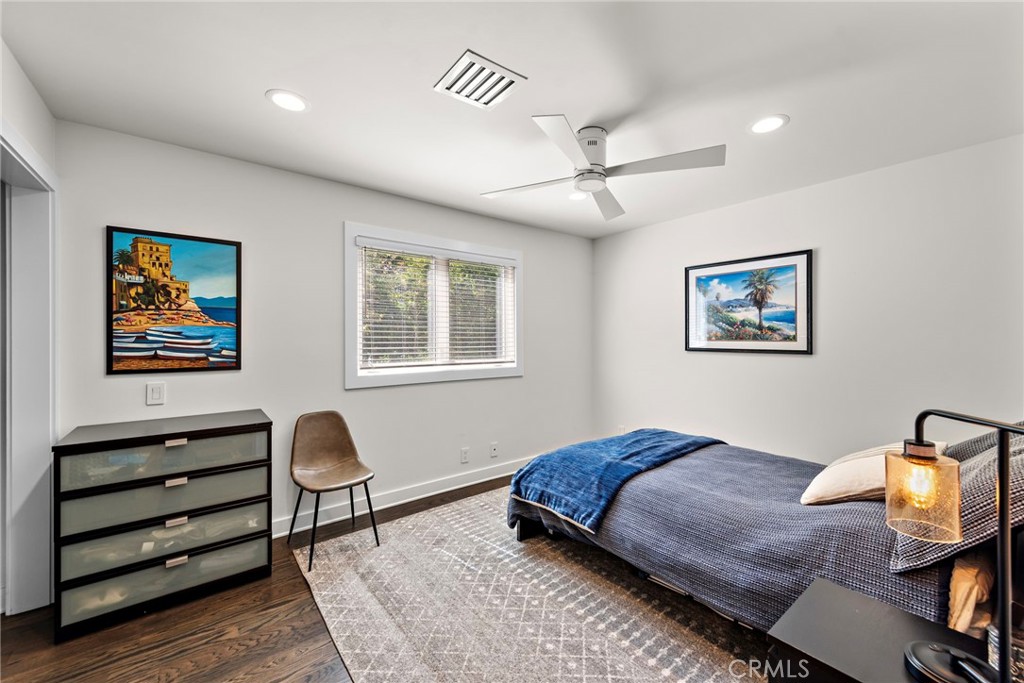 3085 Nestall Road Laguna Beach, CA 92651 - Photo 17 of 33 a bedroom with a bed and wooden floor