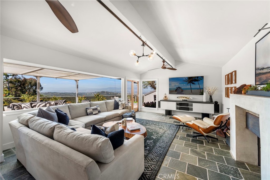 3085 Nestall Road Laguna Beach, CA 92651 - Photo 5 of 33 a living room with furniture a fireplace and a flat screen tv