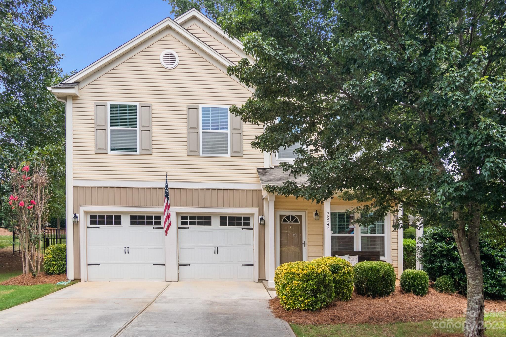 7228 Meyer Road Fort Mill, SC 29715 - Photo 1 of 45 a view of a white house with large windows and a small yard