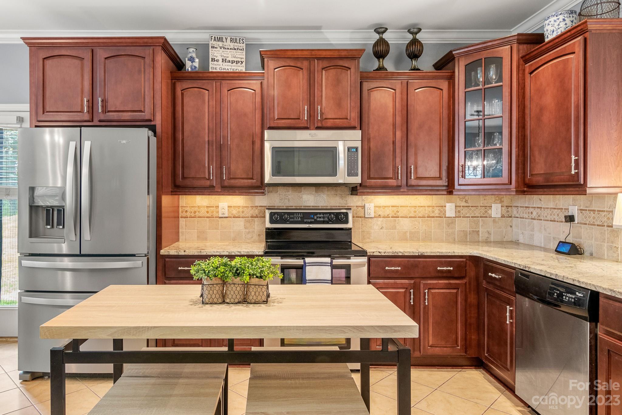 7228 Meyer Road Fort Mill, SC 29715 - Photo 12 of 45 a kitchen with stainless steel appliances granite countertop a refrigerator a stove top oven a sink and dishwasher