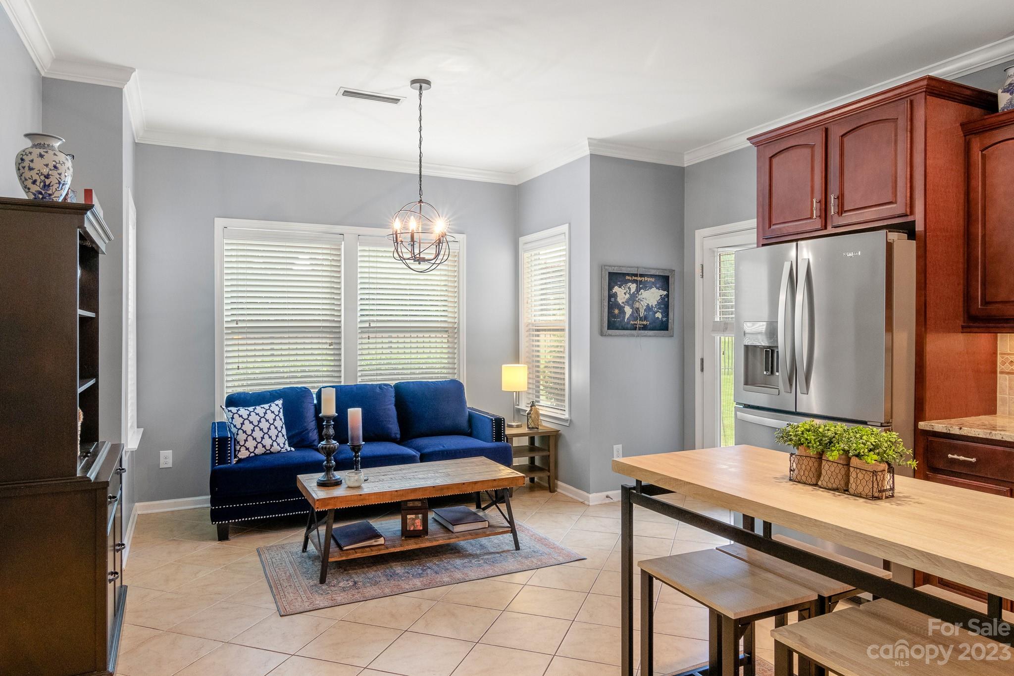 7228 Meyer Road Fort Mill, SC 29715 - Photo 14 of 45 a living room with furniture a large window and a refrigerator