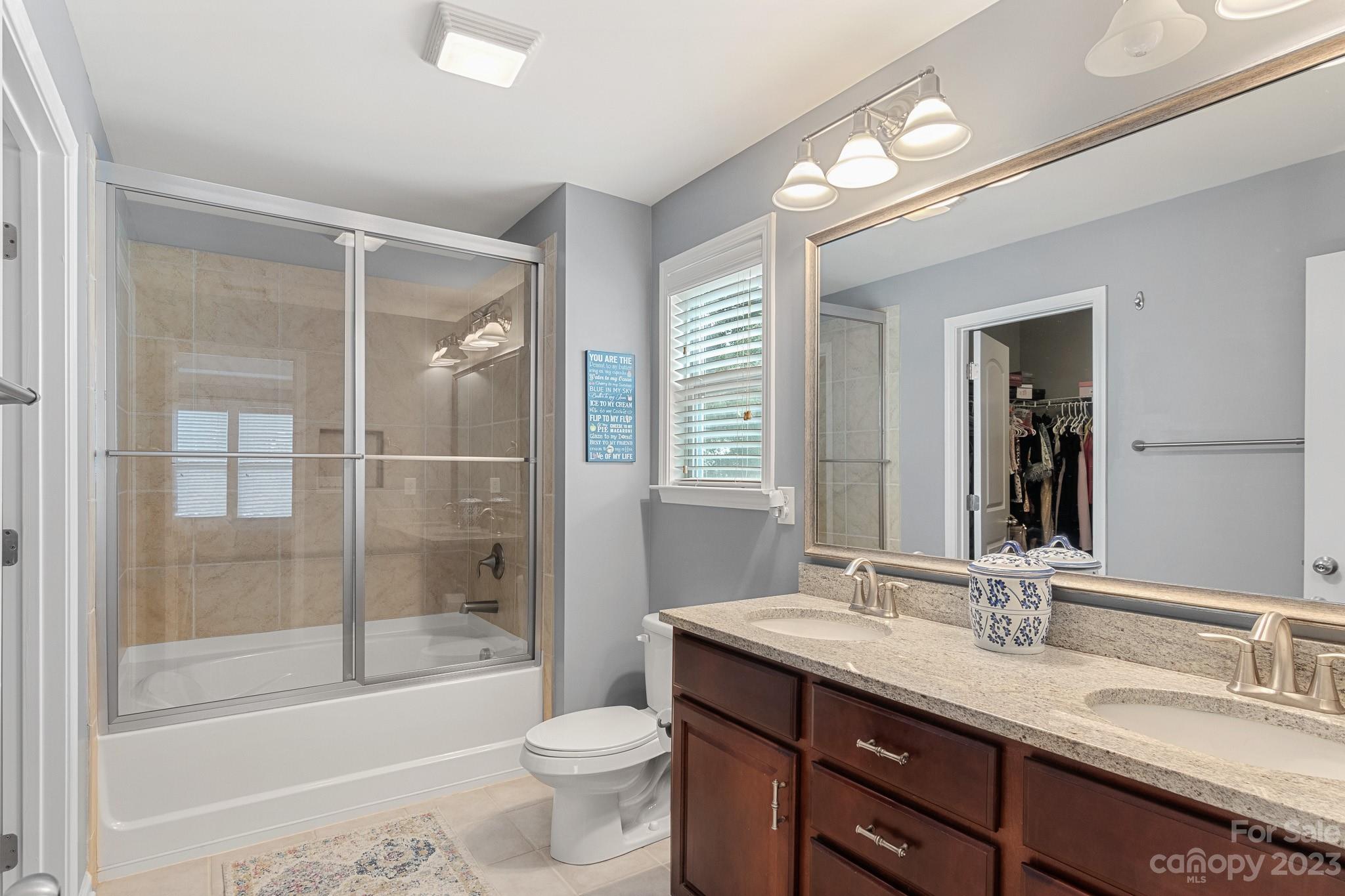 7228 Meyer Road Fort Mill, SC 29715 - Photo 28 of 45 a bathroom with a granite countertop sink toilet mirror and bathtub