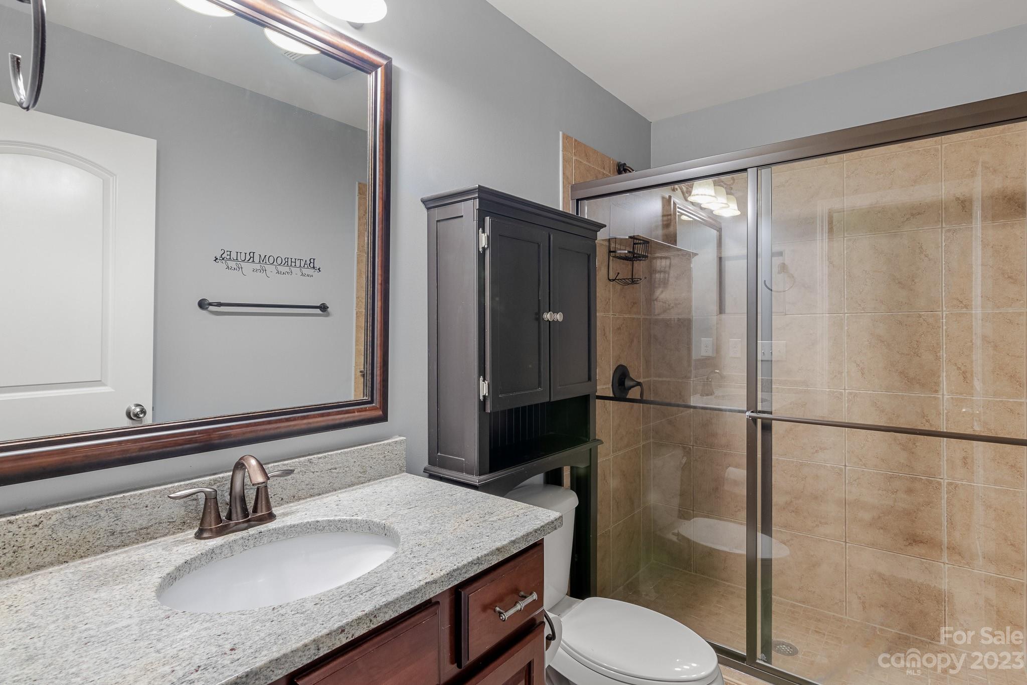 7228 Meyer Road Fort Mill, SC 29715 - Photo 36 of 45 a bathroom with a granite countertop sink toilet and shower