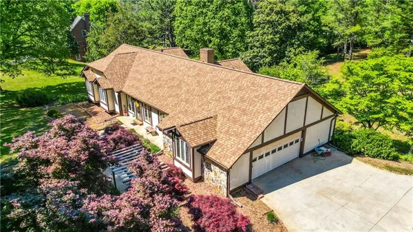 an aerial view of a houses with a yard