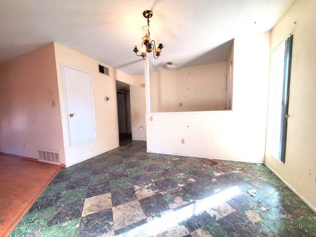 404 Lenore Street Ridgecrest, CA 93555 - Photo 8 of 30 a view of a big room with a chandelier fan and windows