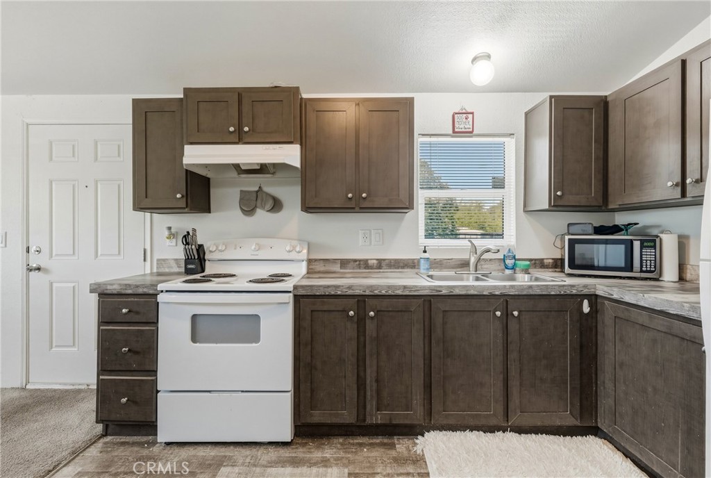 6219 Roland Drive Lucerne, CA 95458 - Photo 11 of 29 a kitchen with a sink stove and microwave