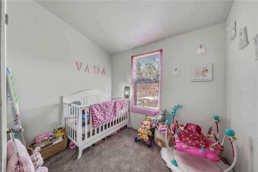 6219 Roland Drive Lucerne, CA 95458 - Photo 12 of 29 a bedroom with a bed and a window
