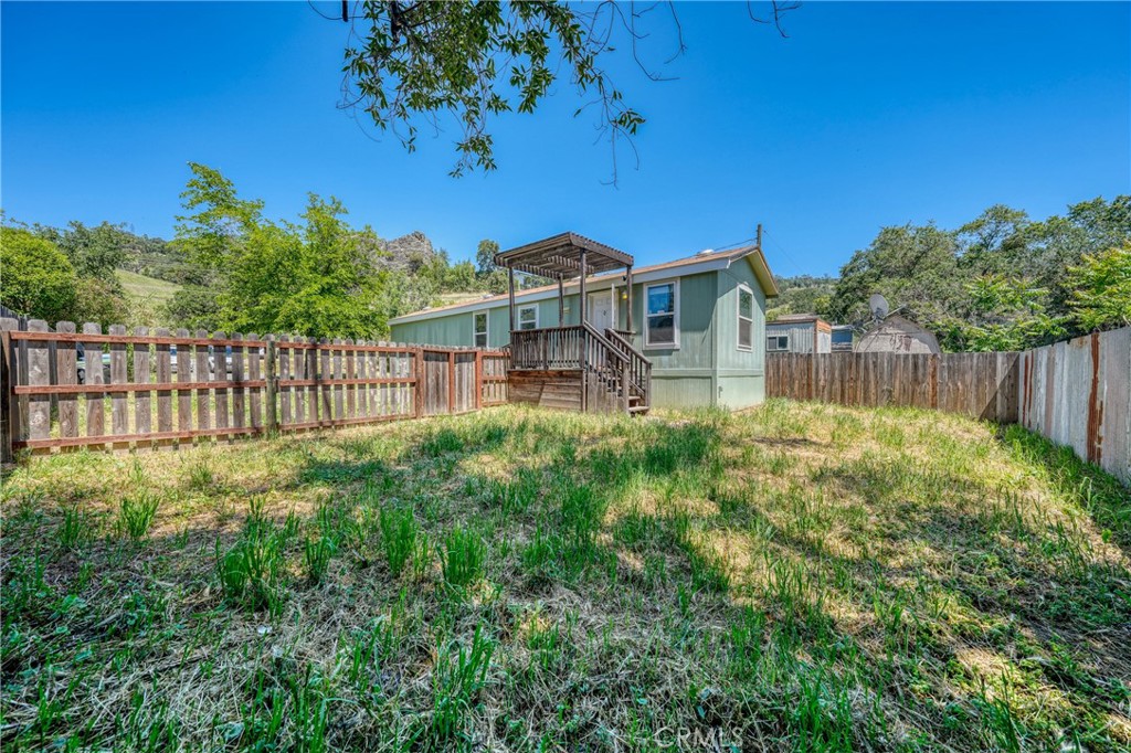 6219 Roland Drive Lucerne, CA 95458 - Photo 18 of 29 a view of a house with a small yard and wooden fence