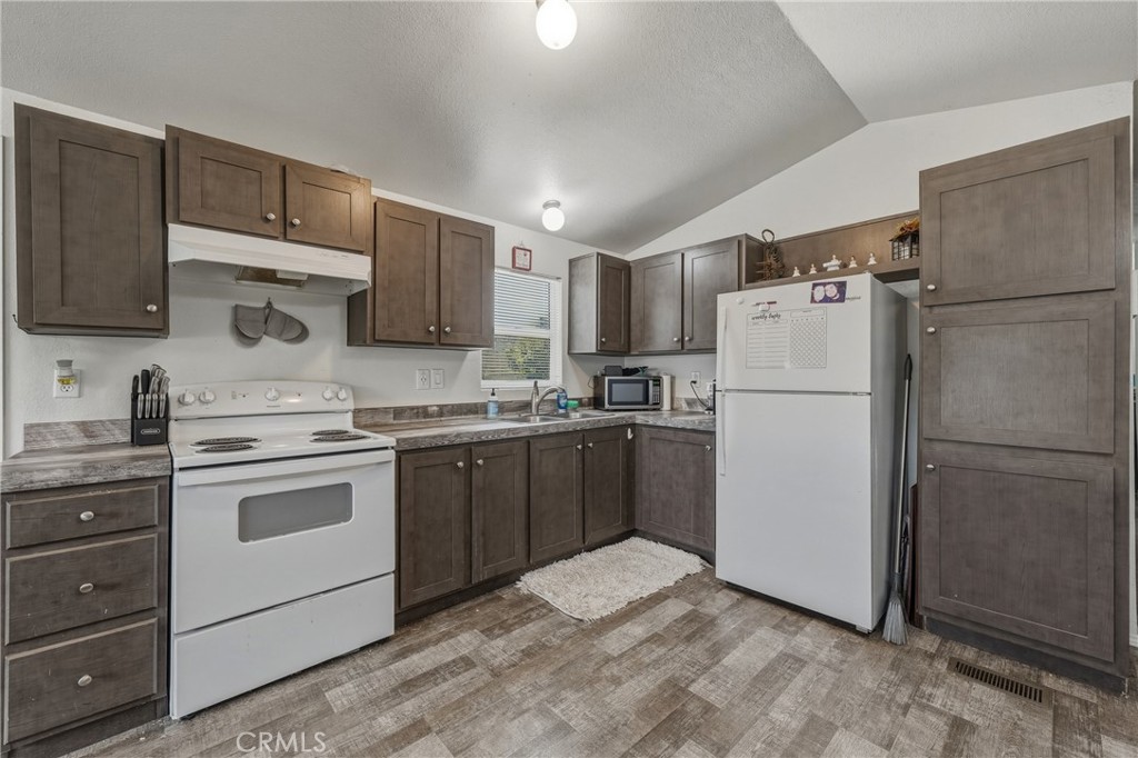 6219 Roland Drive Lucerne, CA 95458 - Photo 9 of 29 a kitchen with a refrigerator sink and cabinets
