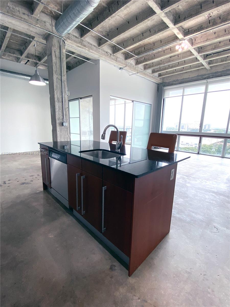 8101 Biscayne Boulevard, Unit R616 Miami, FL 33138 - Photo 8 of 31 a kitchen with granite countertop a sink and a counter top space