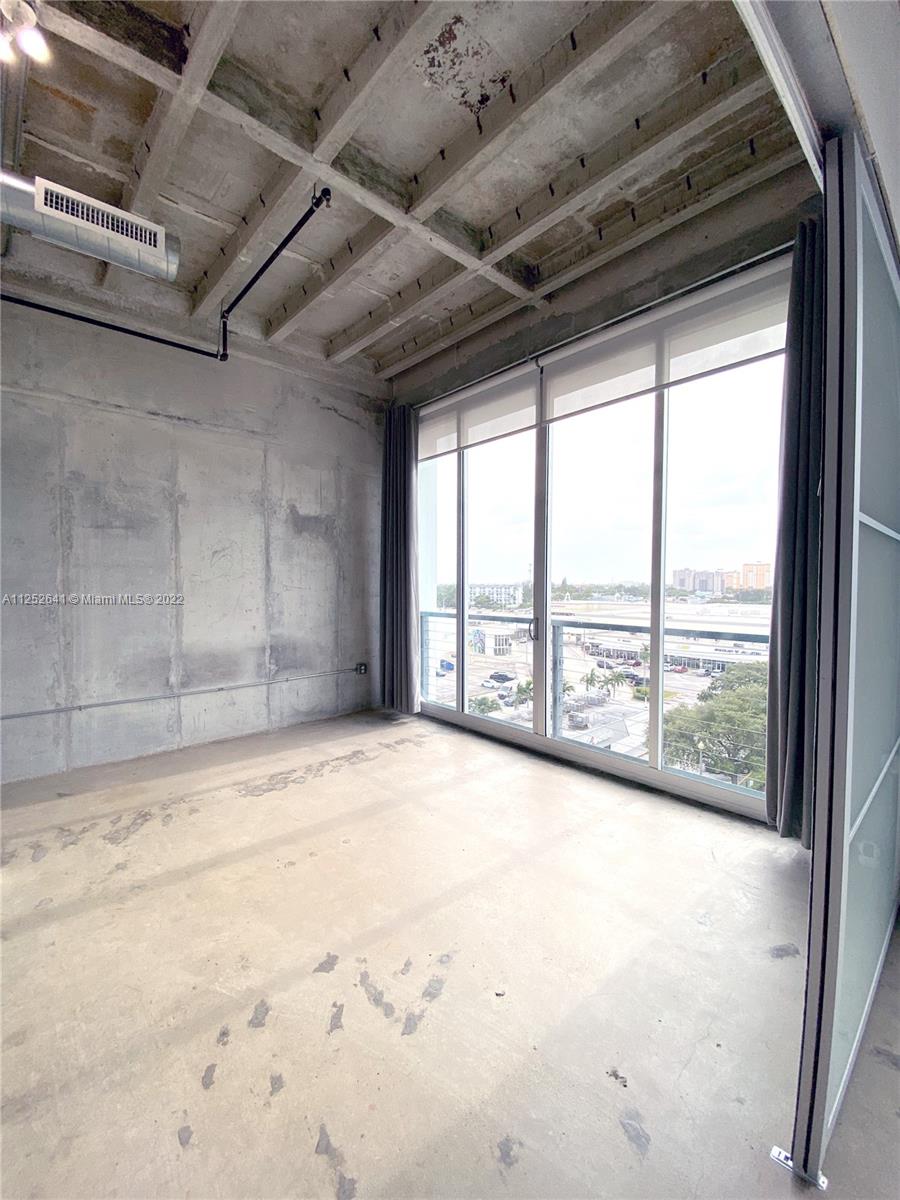 8101 Biscayne Boulevard, Unit R616 Miami, FL 33138 - Photo 10 of 31 a view of an empty room with a balcony