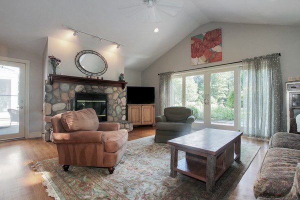 18 Pine Brook Road Wayland, MA 01778 - Photo 10 of 20 a living room with furniture fireplace and a large window