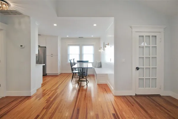 a view of a room with wooden floor and furniture
