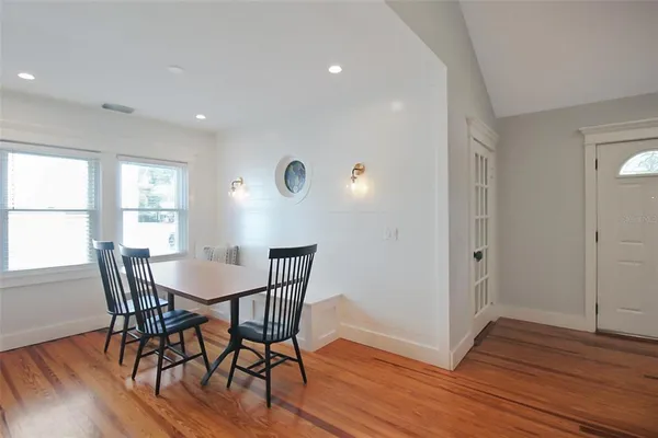 a view of a dining room with furniture and wooden floor