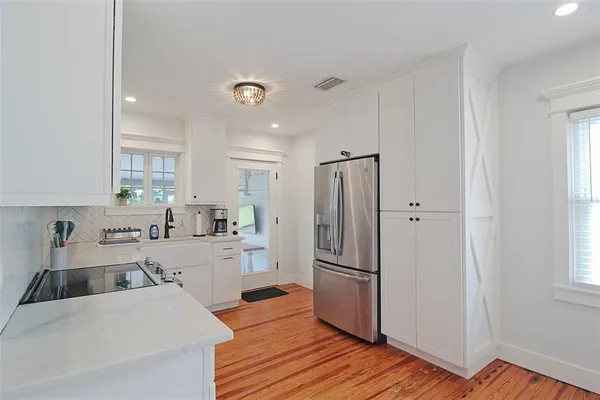 a kitchen with stainless steel appliances a refrigerator and a stove top oven