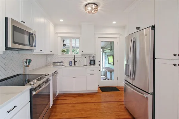 a kitchen with a refrigerator sink and stove