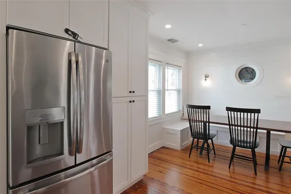 a view of a dining room with furniture window and wooden floor