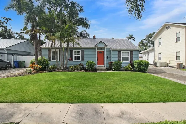 a front view of a house with a garden