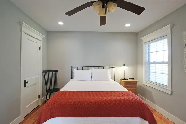 a bedroom with a large bed and a window