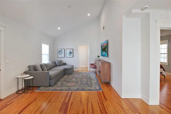 a living room with furniture and a wooden floor