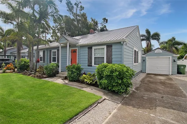 a front view of a house with a garden