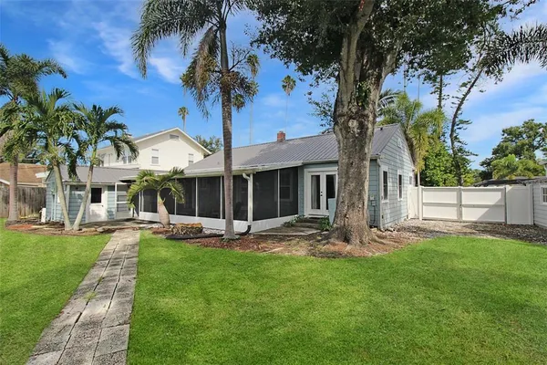 a front view of a house with garden and patio